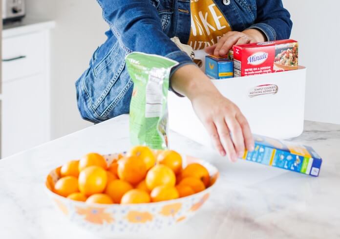 Andrea Brame | Nolensville, TN home organizer | hands reaching to organize a kitchen bin