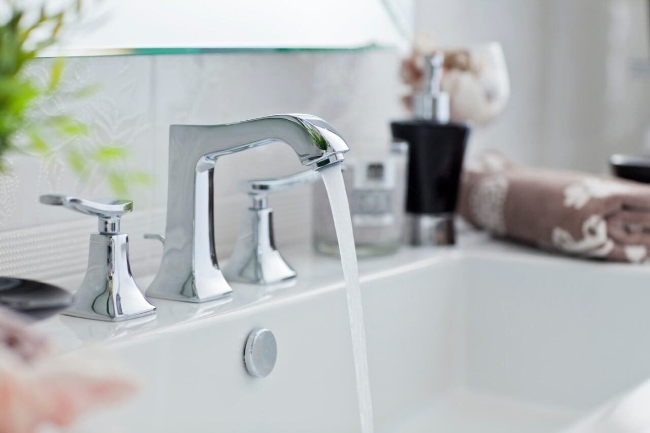 clean bathroom sink with running water