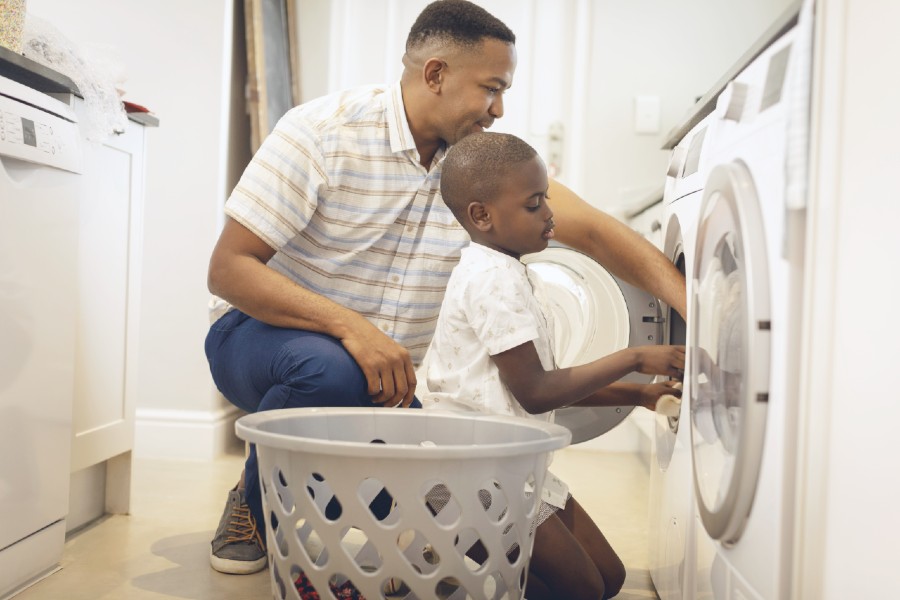 Dad and son doing laundry together