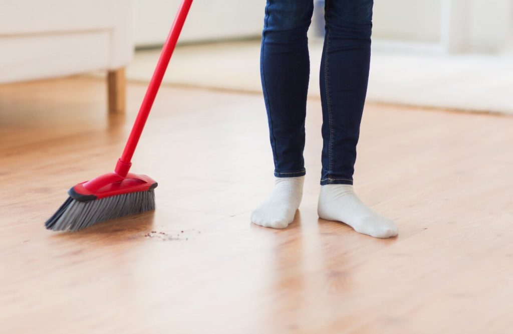 woman sweeping floor