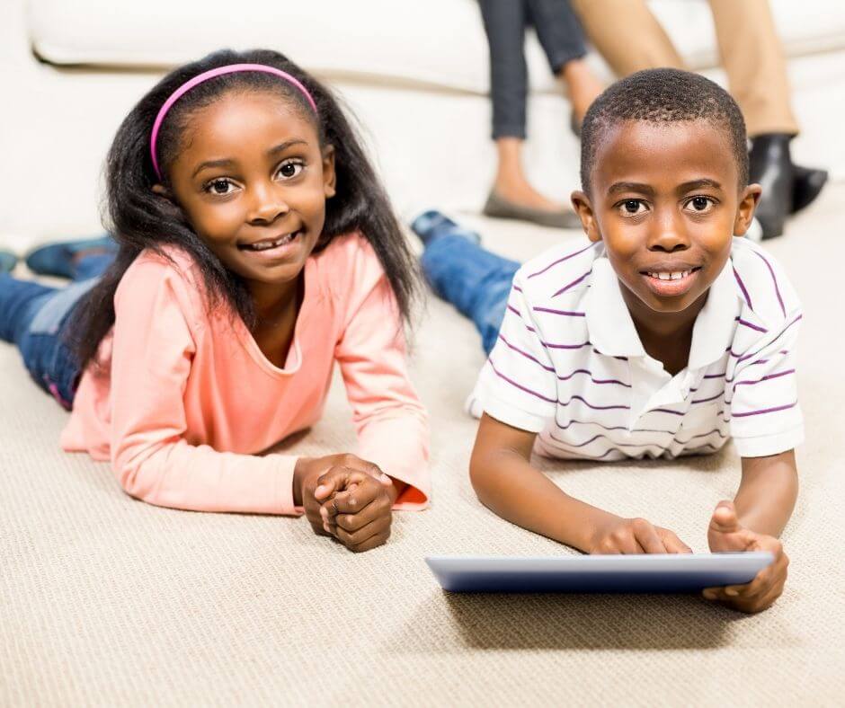 African American boy and girl playing on a tablet