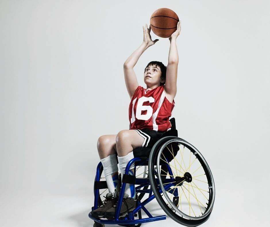 young teenage or preteen boy in a wheelchair, shooting a basketball