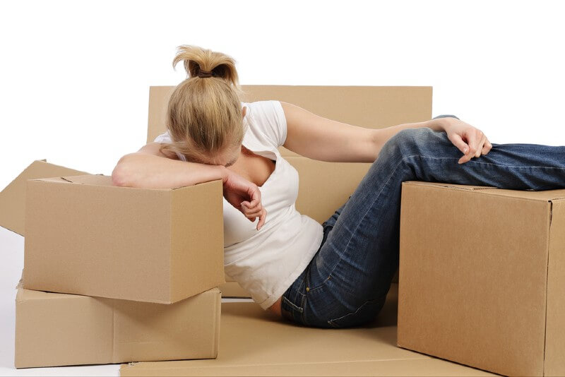 Tired woman with moving boxes