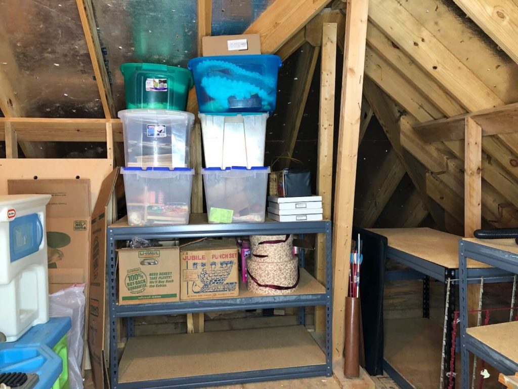 plastic bins full of storage in the cleaned out attic