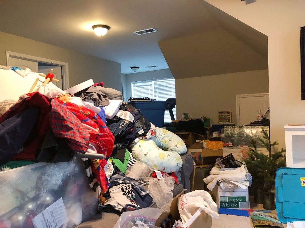 very full staging area with table overflowing with clutter