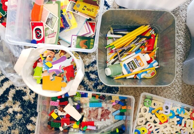 Bins filled with toys being decluttered